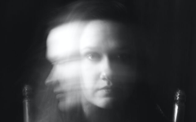 Black and white image of woman's face in slow exposure -- front and profile