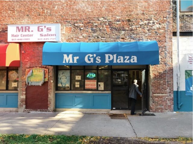 Front door of Mr G’s Plaza with sign on top.